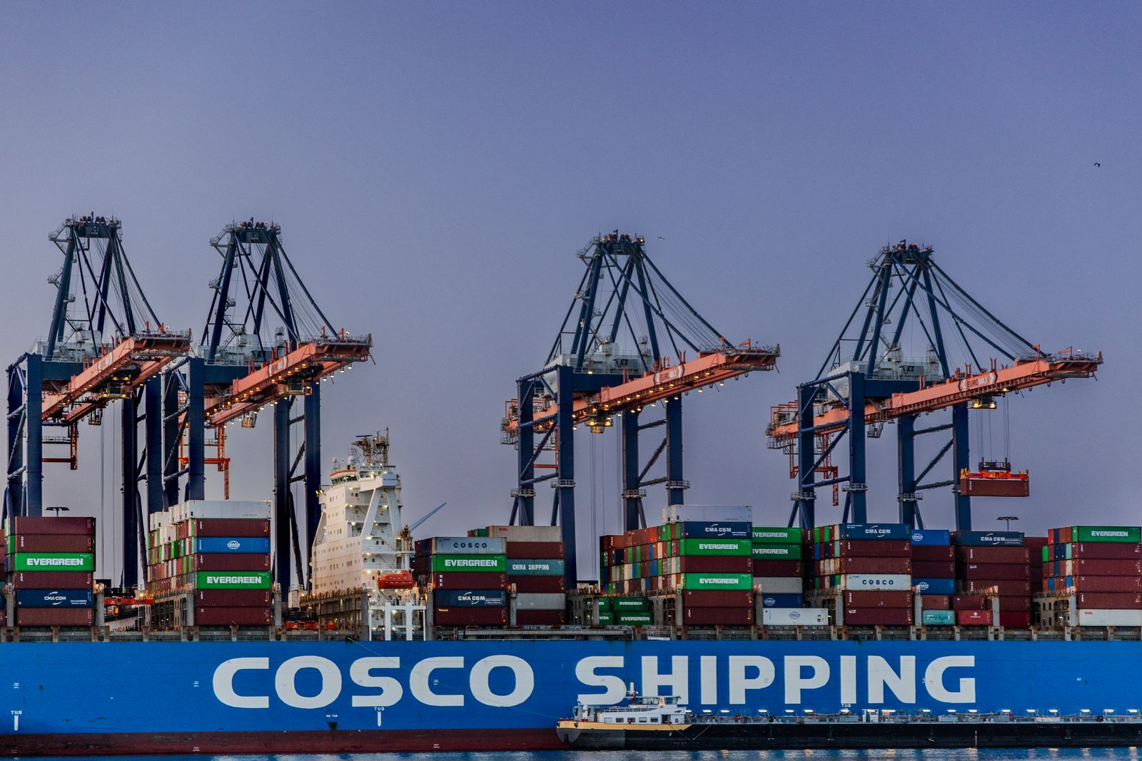 Cranes and shipping containers at Rotterdam’s Maasvlakte terminal in evening light